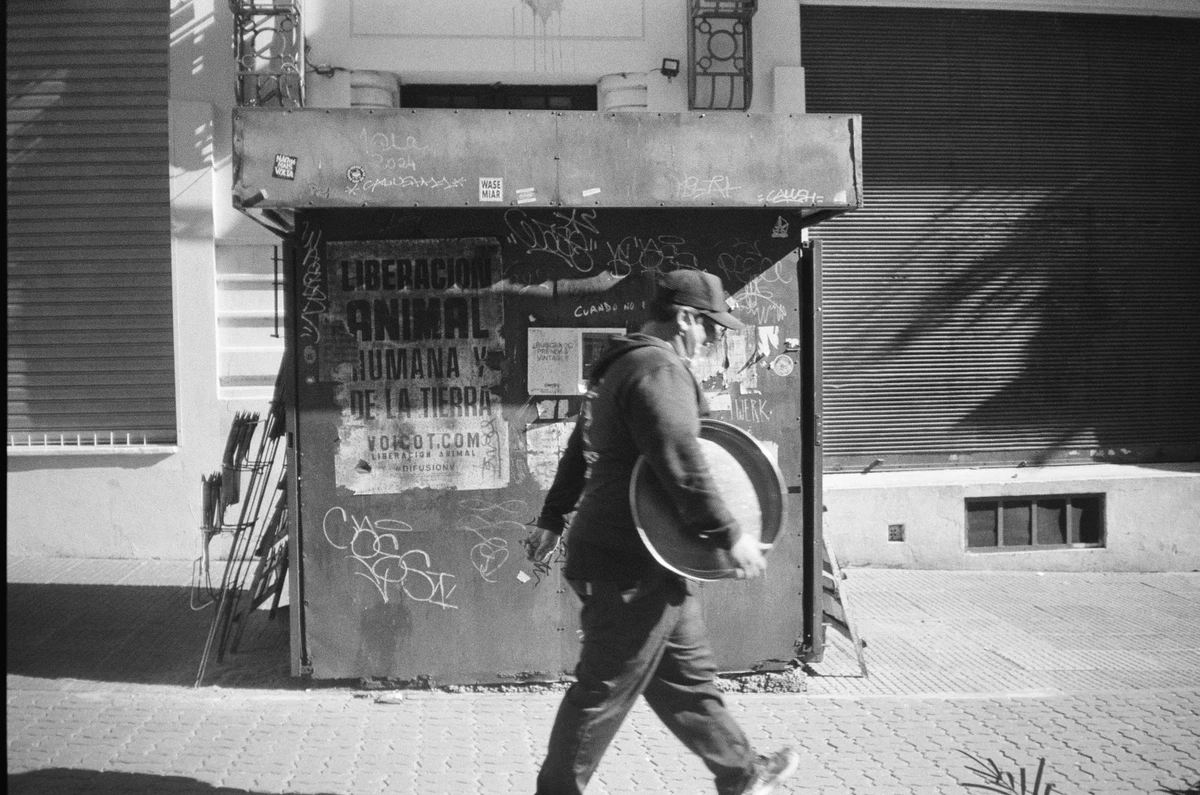 Black and white photo of a worker walking on the street