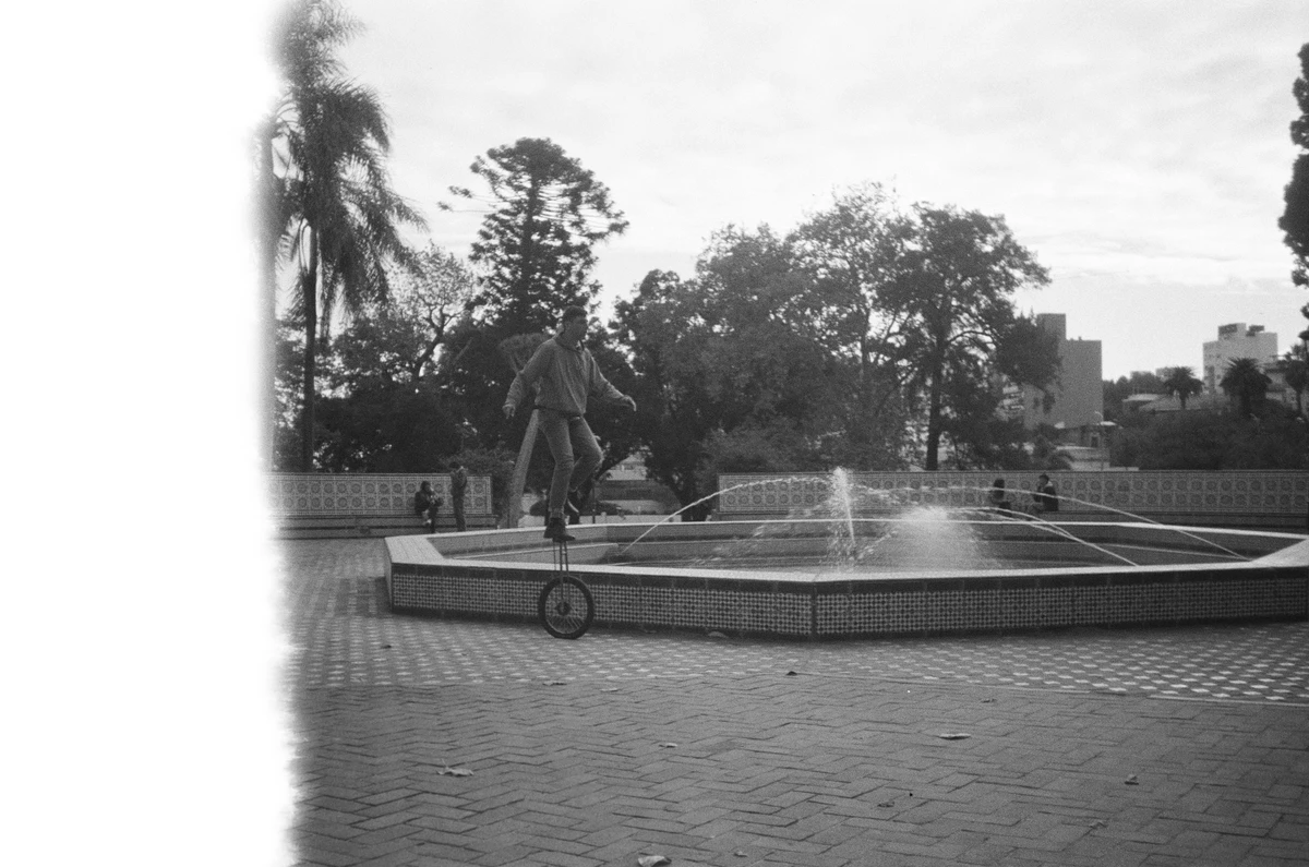 Black and white photo of a man on a unicycle